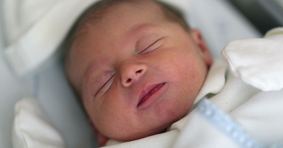 A newborn infant sleeps.