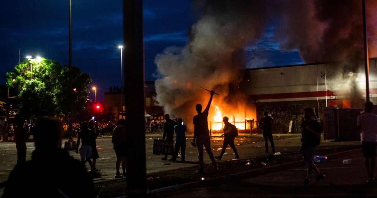 A fire burns inside of an Auto Zone store near the 3rd Police Precinct in Minneapolis on May 27, 2020, amid riots following the death of George Floyd.