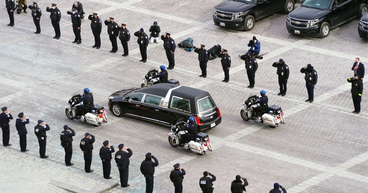 A hearse leaves with the cremated remains of Capitol Police Officer Brian Sicknick after he lay in honor at the U.S. Capitol in Washington on Feb. 3.