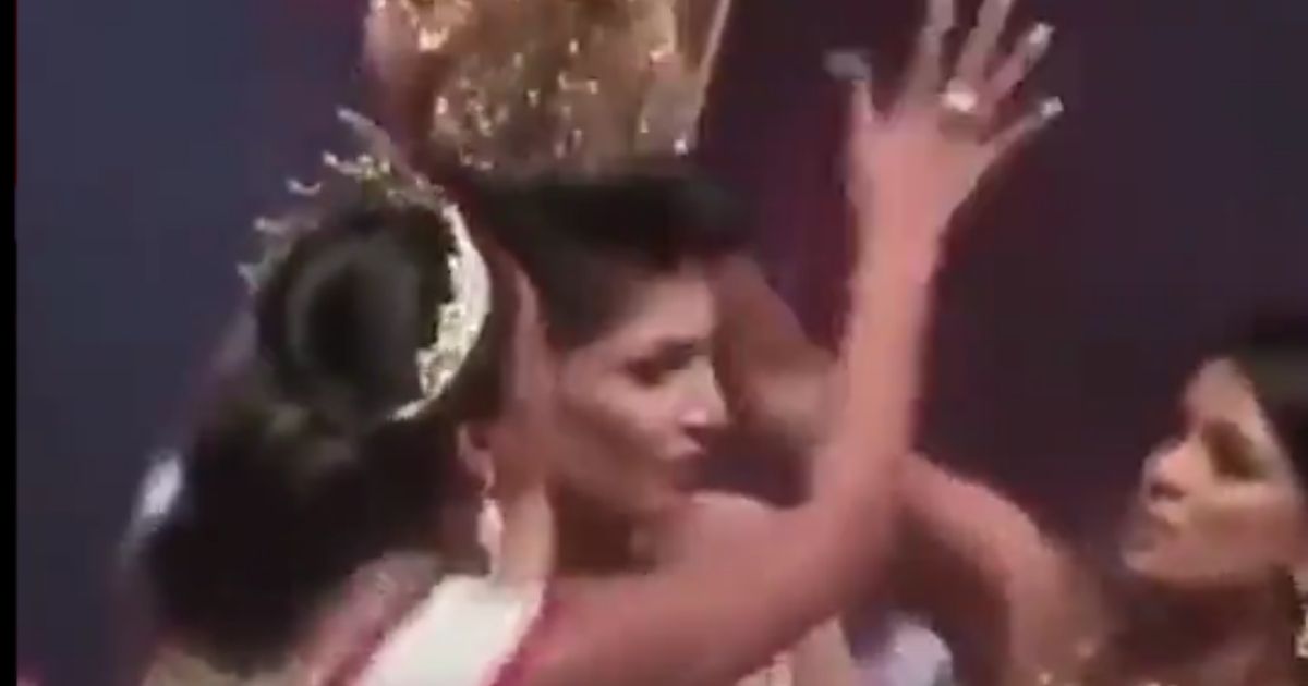 Caroline Jurie, left, the reigning Mrs. World, starts to pull the crown off the head of Pushpika De Silva, who had just won the Mrs. Sri Lanka title at a beauty pageant in Colombo, Sri Lanka, on April 4, 2021. Jurie later was charged with 'simple hurt and criminal force.'