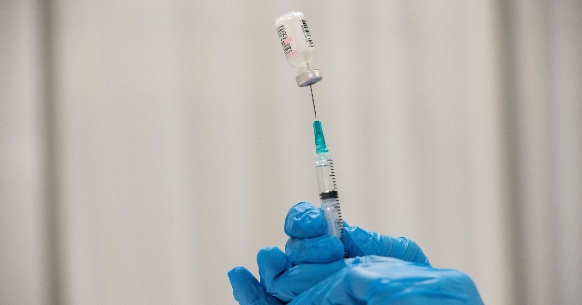 A pharmacist reconstitutes the Pfizer-BioNTech Covid-19 vaccine as she fills syringes with the vaccine for the incoming public at the UMass Memorial Health Care Covid-19 Vaccination Center in the Mercantile Center in Worcester, Massachusetts, on Thursday.