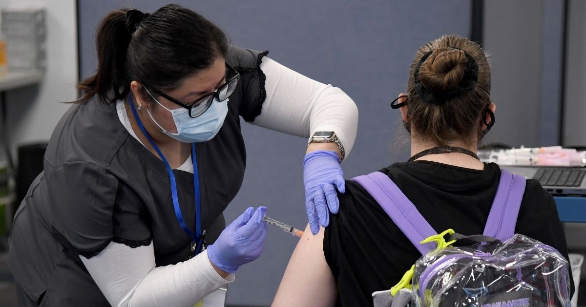 Nurse gives woman vaccine