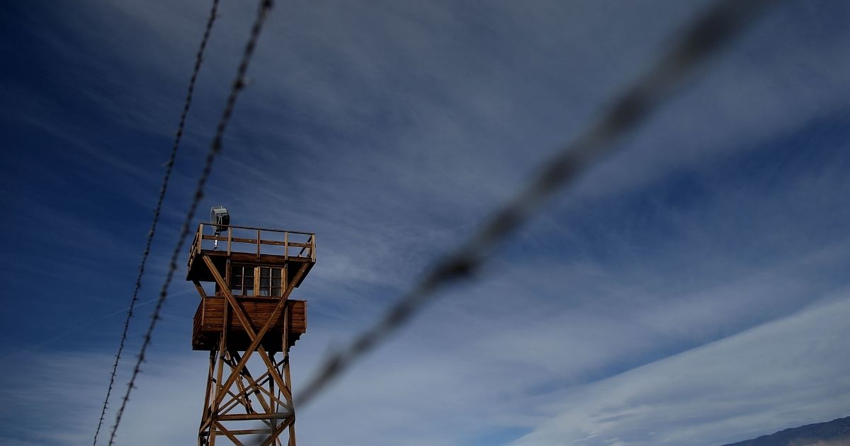 A replica of a guard tower stands near barbed wire fencing at Manzanar National Historic Site on Dec. 9, 2015, near Independence, California.