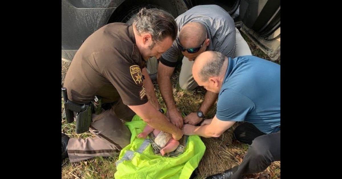First responders working on the 4-month-old baby boy that was found face-down in the woods.