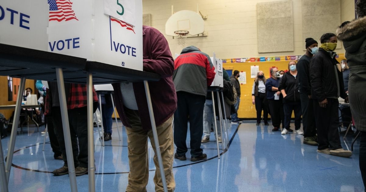 Voters fill out their ballots at a school gymnasium on Nov. 3, 2020, in Lansing, Michigan.