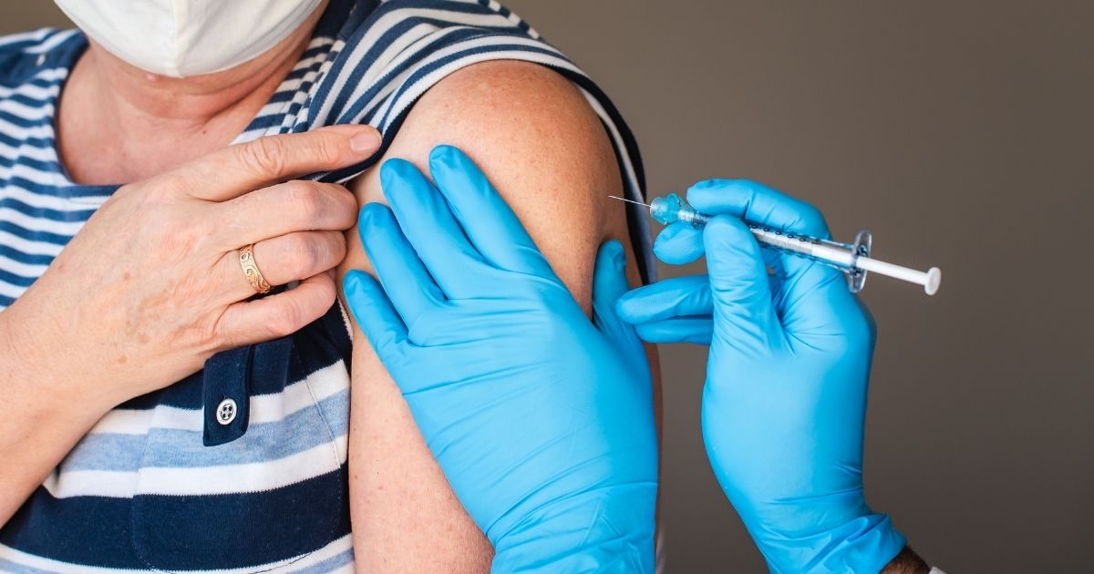 A woman receives a vaccination in this stock image.