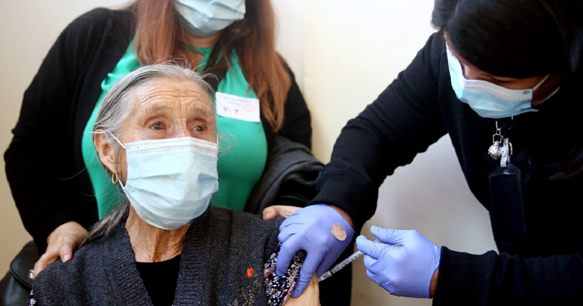 An elderly woman receives her first dose of the Pfizer COVID-19 vaccination at a clinic last week in Los Angeles.