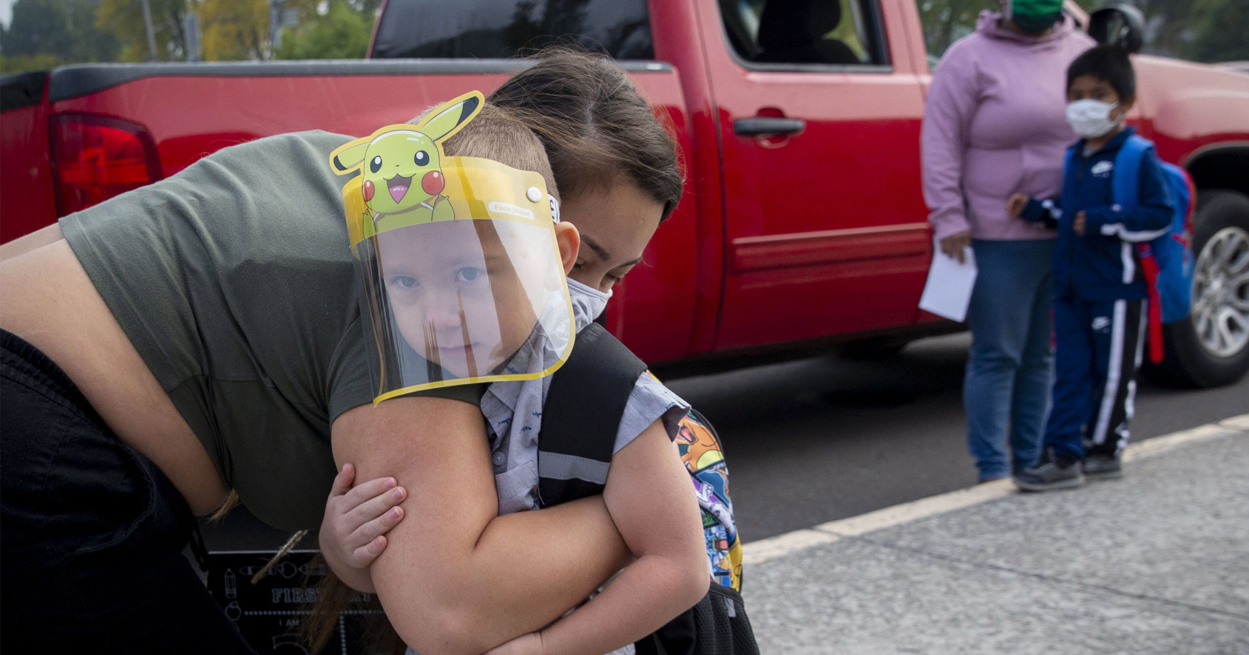 Vanessa Mendez hugs her son, Evan Seppa, as he prepares to head into Elizabeth Page Elementary School for his first day of kindergarten in Springfield, Oregon, on Sept. 21, 2020.