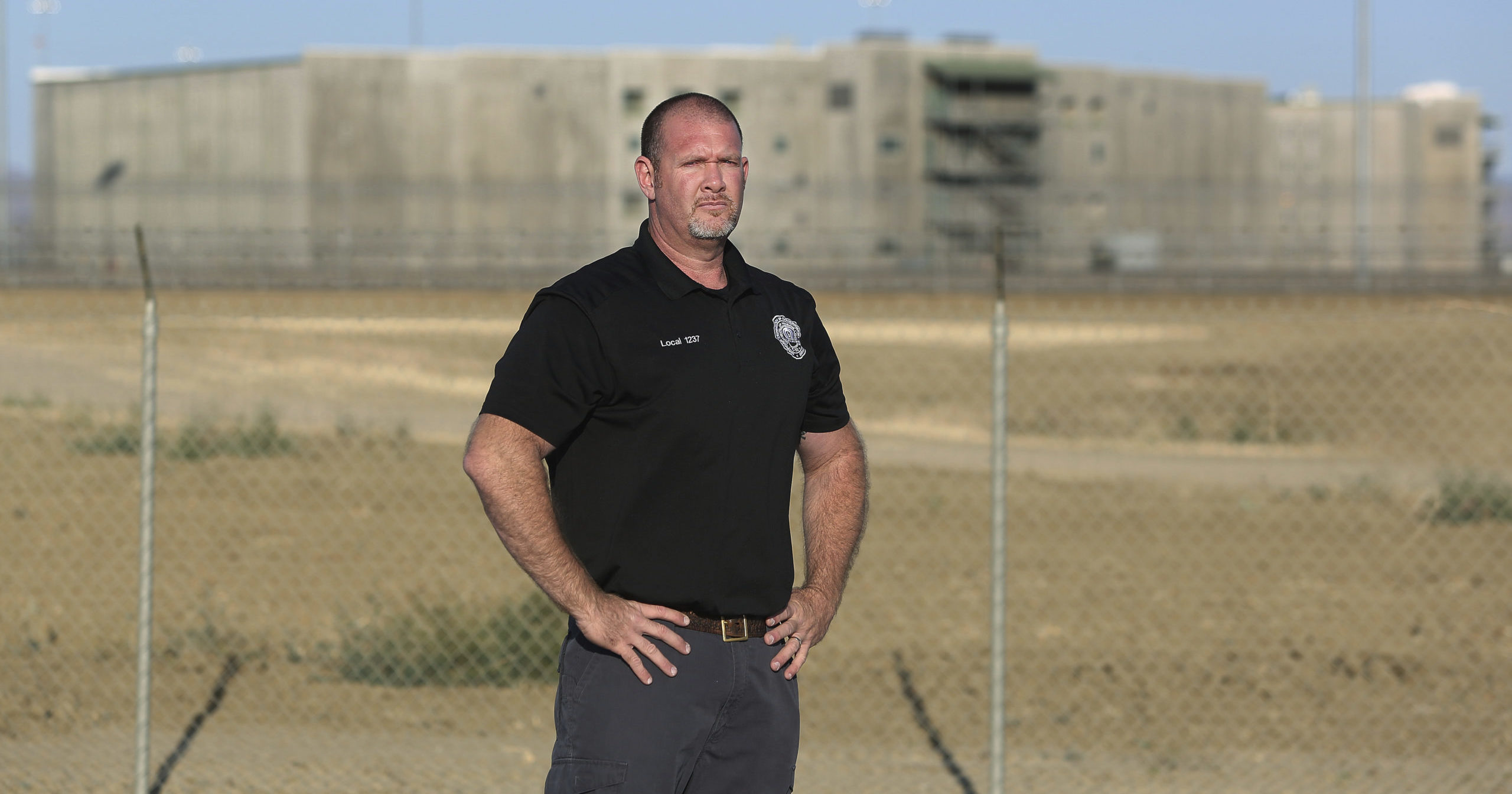 Aaron McGlothin, union president at the Federal Correctional Institution at Mendota, stands in front of the prison during a protest against staffing shortages in Mendota, California, on Monday.