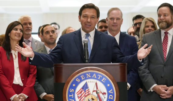 Surrounded by lawmakers, Florida Gov. Ron DeSantis speaks at the end of a legislative session Friday at the Capitol in Tallahassee, Florida.