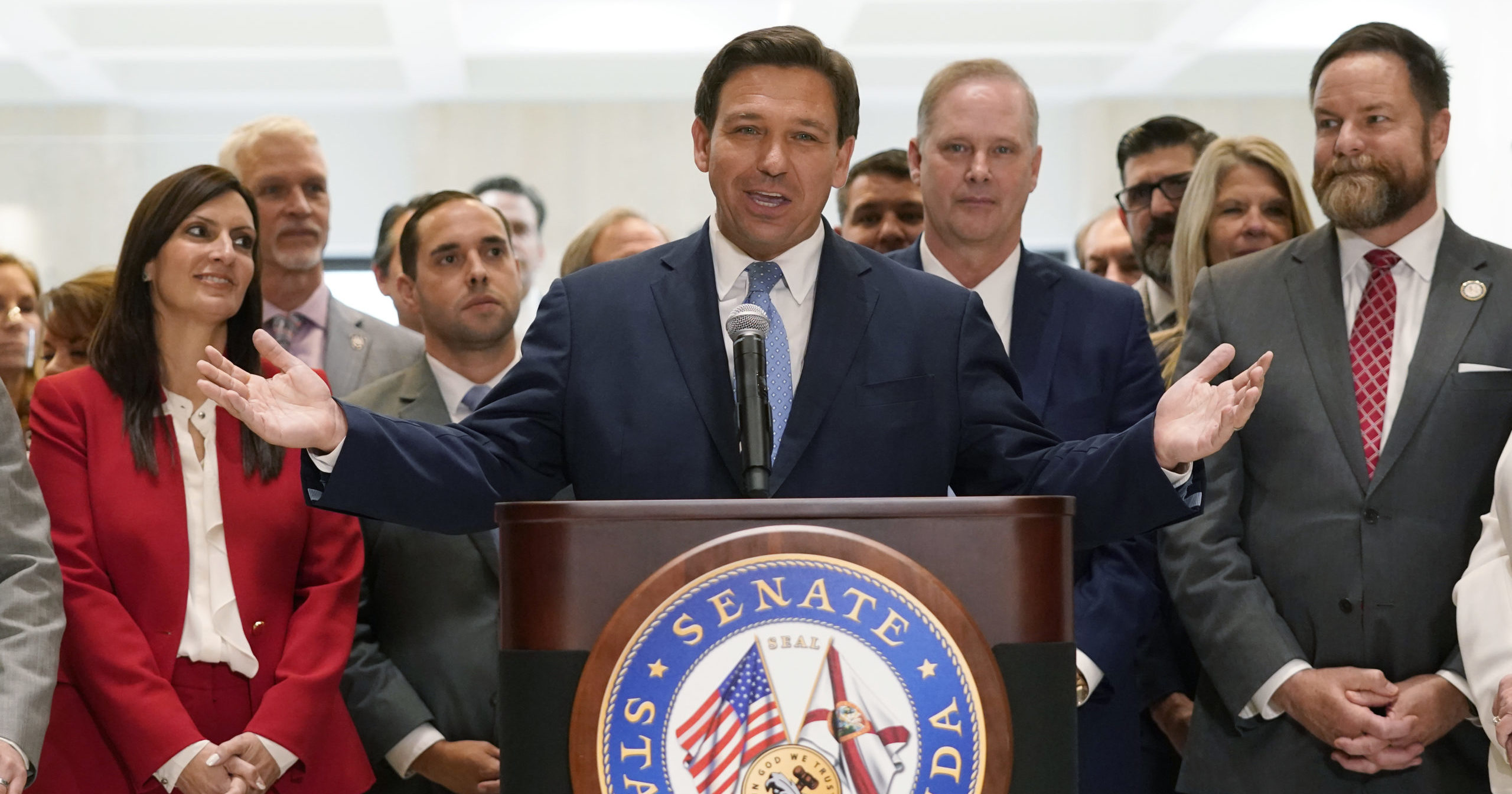 Surrounded by lawmakers, Florida Gov. Ron DeSantis speaks at the end of a legislative session Friday at the Capitol in Tallahassee, Florida.