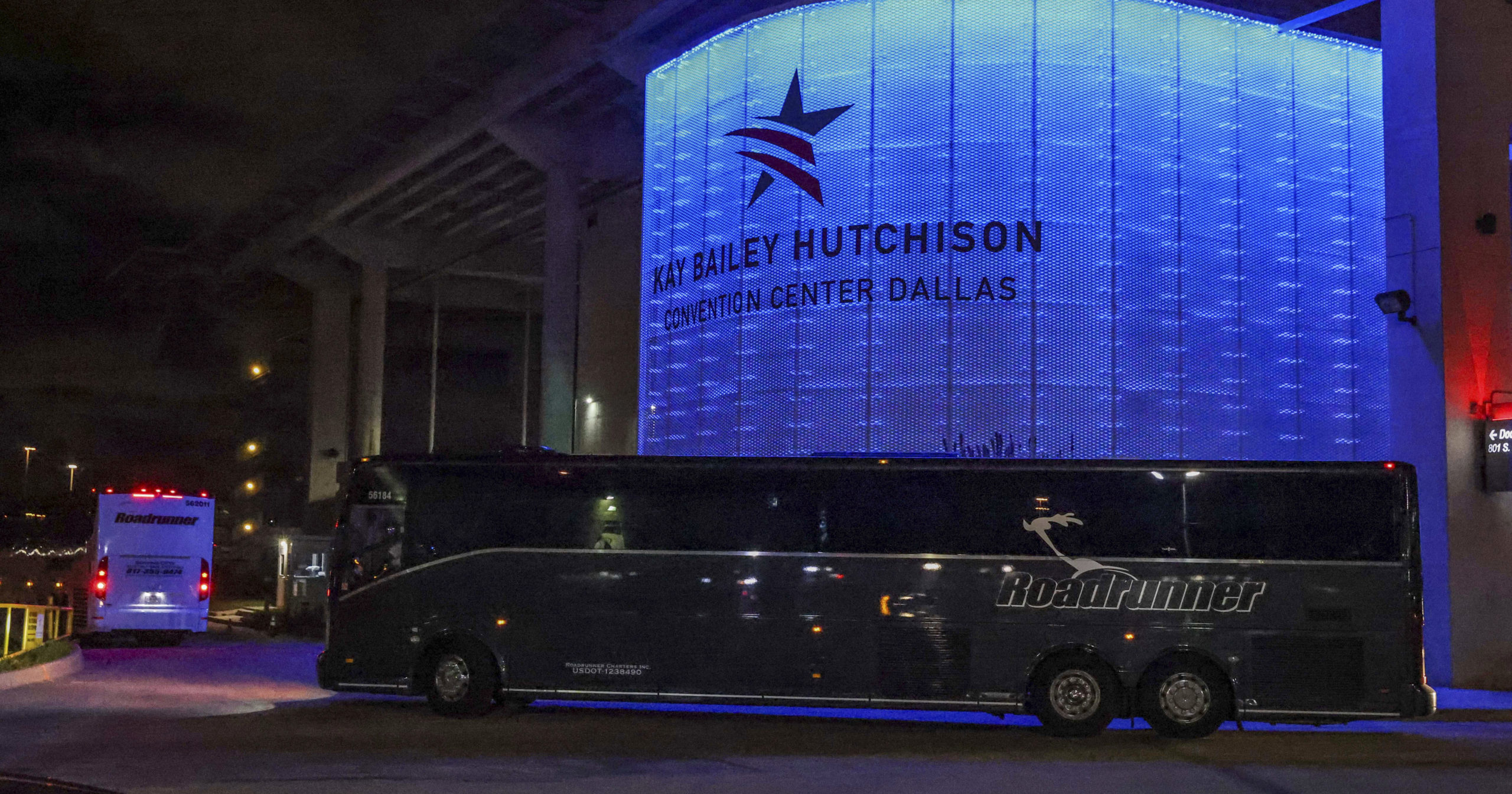Charter buses arrive at the Kay Bailey Hutchison Convention Center in Dallas on March 17, 2021