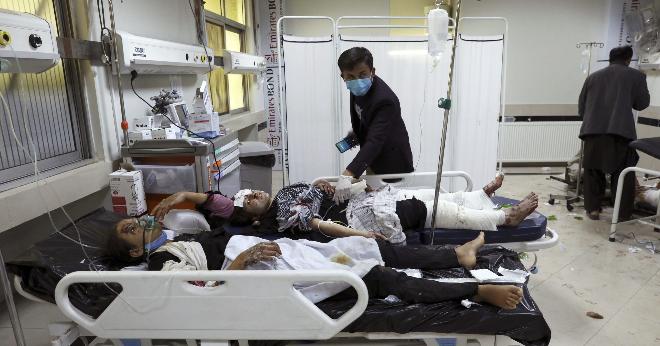 Afghan students are treated at a hospital after a bombing near a school in Kabul, Afghanistan, on Saturday