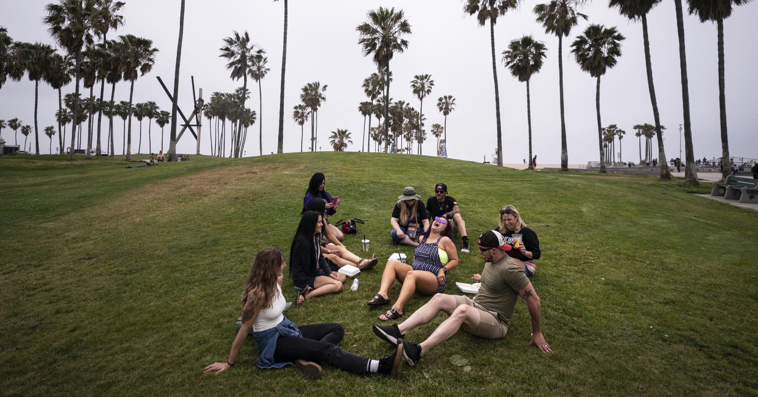 A group of friends mingle on the beach in Los Angeles on May 5, 2021.