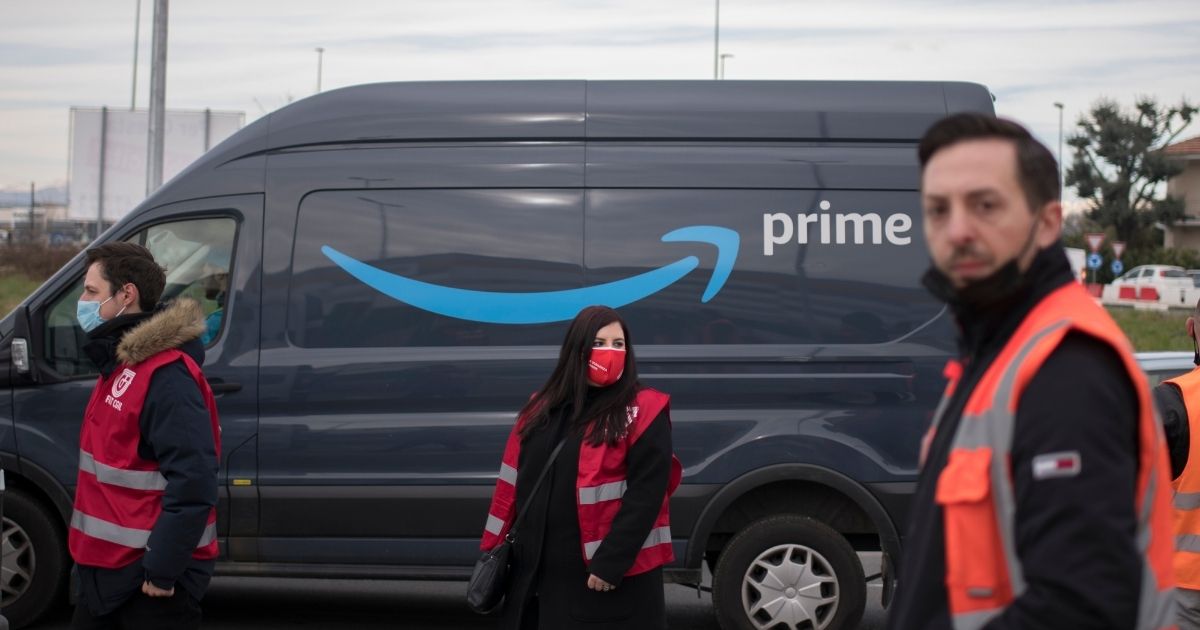 Amazon workers demonstrate for better working conditions near an Amazon Prime delivery truck on March 22, 2021 in Brandizzo near Turin, Italy.