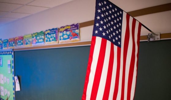 An American flag is pictured in a classroom in the stock image above.