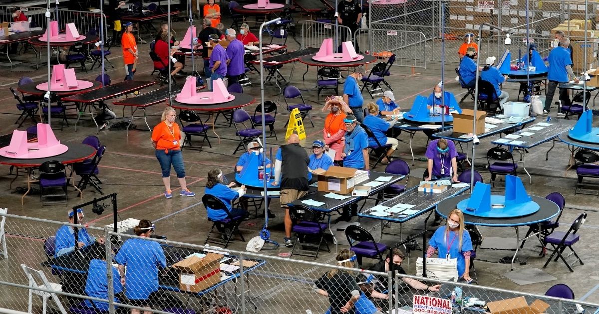 Maricopa County ballots cast in the 2020 general election are examined and recounted by contractors working for Florida-based company Cyber Ninjas on May 6, 2021, at Veterans Memorial Coliseum in Phoenix.