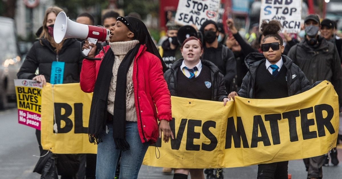 Black Lives Matter activist Sasha Johnson speaks at a protest as BLM supporters march from Park View School to Tottenham Police Station on Dec. 11, 2020, in London, England.