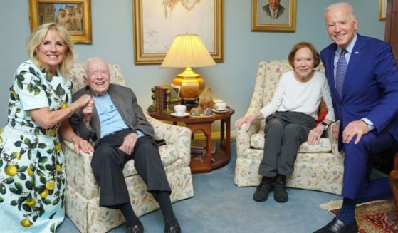President Joe Biden, far right, and his wife Jill Biden, far left, take a photo with former President Jimmy Carter, center left, and his wife Rosalynn Carter.