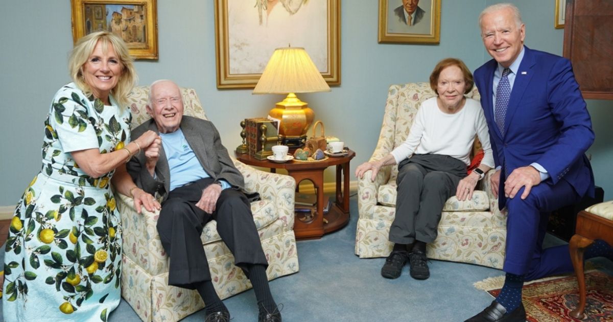 President Joe Biden, far right, and his wife Jill Biden, far left, take a photo with former President Jimmy Carter, center left, and his wife Rosalynn Carter.