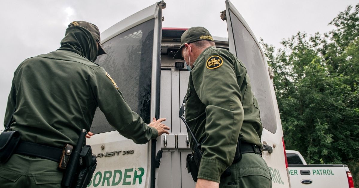 Border Patrol agents prepare to transport illegal immigrants to a processing facility in Del Rio, Texas, on Monday.