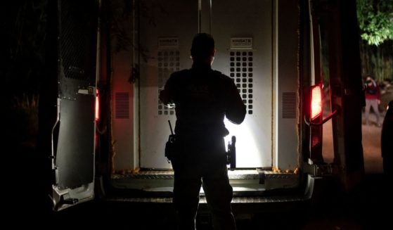 A Border Patrol agent closes the door of a transport vehicle after loading a group of illegal immigrants who were apprehended near the border between Mexico and the United States in Del Rio, Texas, on May 16.