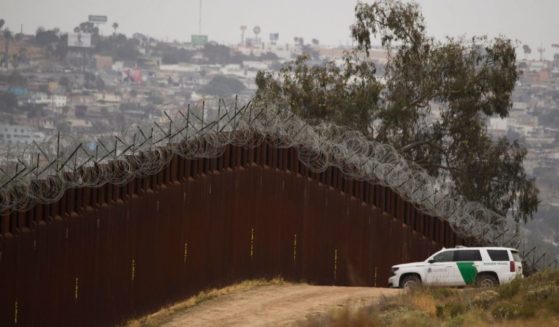 A Border Patrol vehicle sits next to a new section of the steel bollard-style wall along the U.S.-Mexico border between Tijuana, left, and San Diego on May 10.
