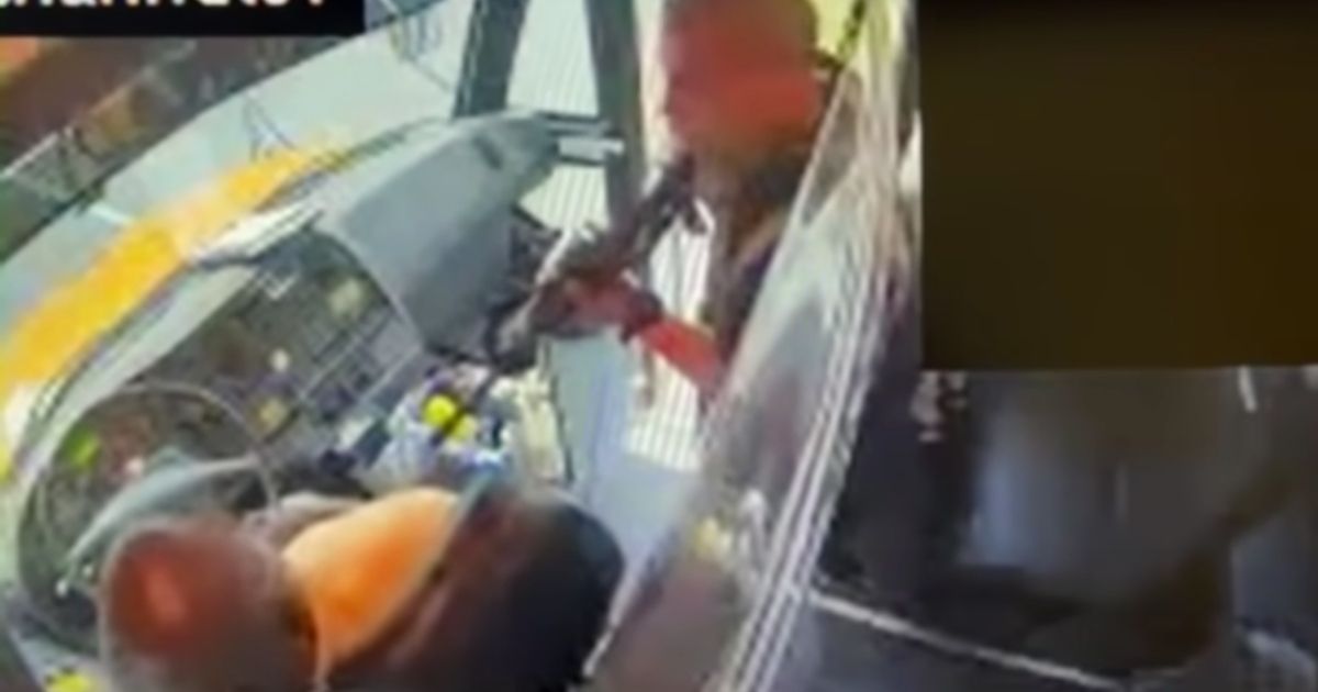 School bus surveillance video shows the suspect pointing a gun at the school bus driver