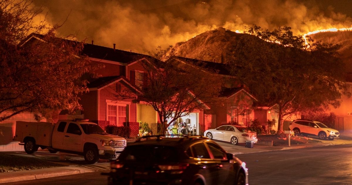 Flames come close to houses during the Blue Ridge Fire on Oct. 27, 2020, in Chino Hills, California.