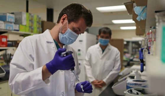 A lab technician prepares a solution that will be used to process COVID-19 test samples at Advagenix, a molecular diagnostics laboratory, on Aug. 5, 2020, in Rockville, Maryland.