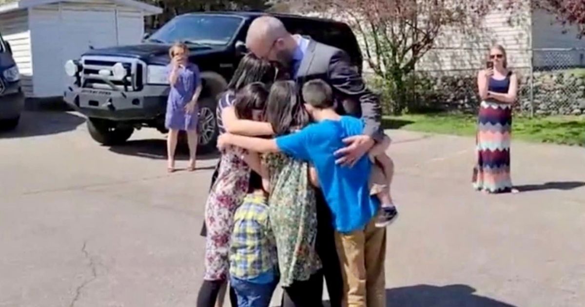Pastor Tim Stephens of Fairview Baptist Church in Calgary, Alberta, Canada, hugs his family before being arrested on Sunday.