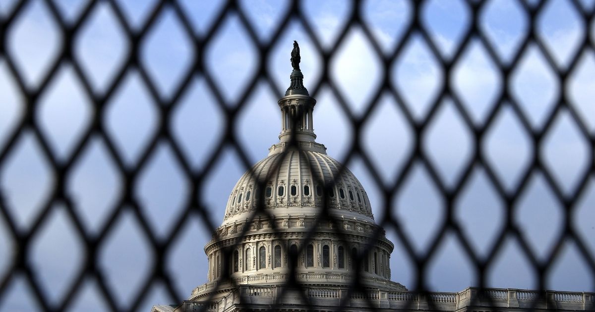 The U.S. Capitol is seen through security fencing on May 12, 2021, in Washington, DC.