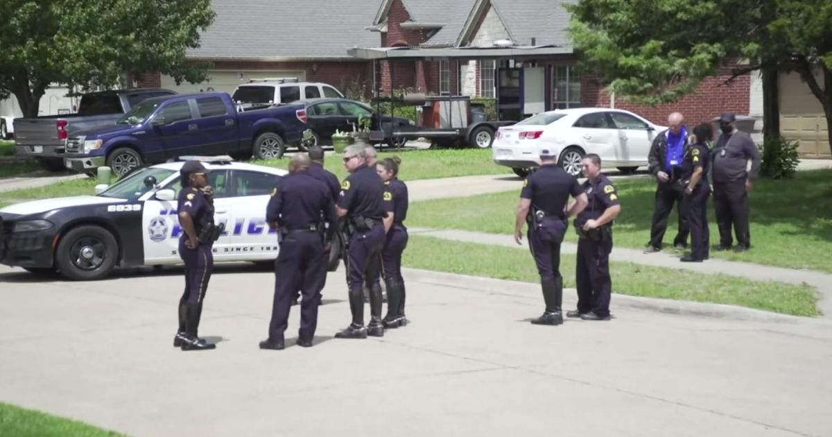Law enforcement officers gather near where 4-year-old Cash Gernon was found dead in Dallas.