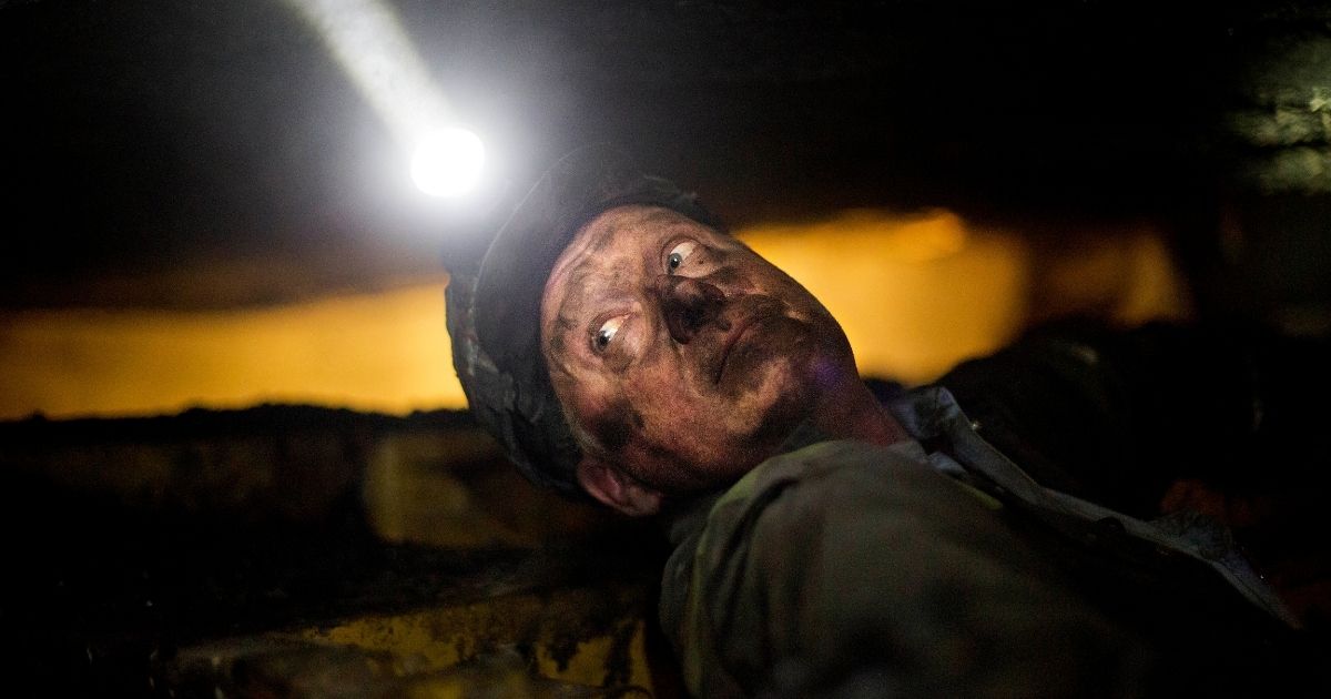 Scott Tiller, a coal miner of 31 years at the time, takes a break while operating a continuous miner machine in a coal mine about 40 inches high in Welch, West Virginia, on Oct. 6, 2015.