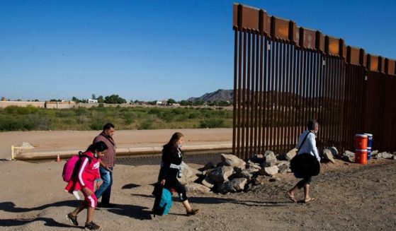 Migrants from Colombia cross the U.S.-Mexico border to turn themselves over to authorities on Thursday in Yuma, Arizona.