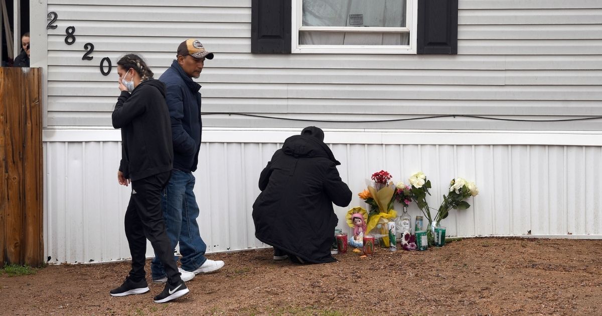 Mourners organize a memorial on Monday outside a mobile home in Colorado Springs, Colorado, where a shooting took place at a party on Sunday.