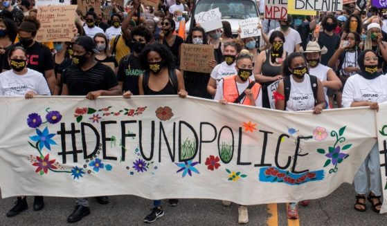 Demonstrators calling to defund the Minneapolis Police Department march on the city's University Avenue on June 6, 2020.
