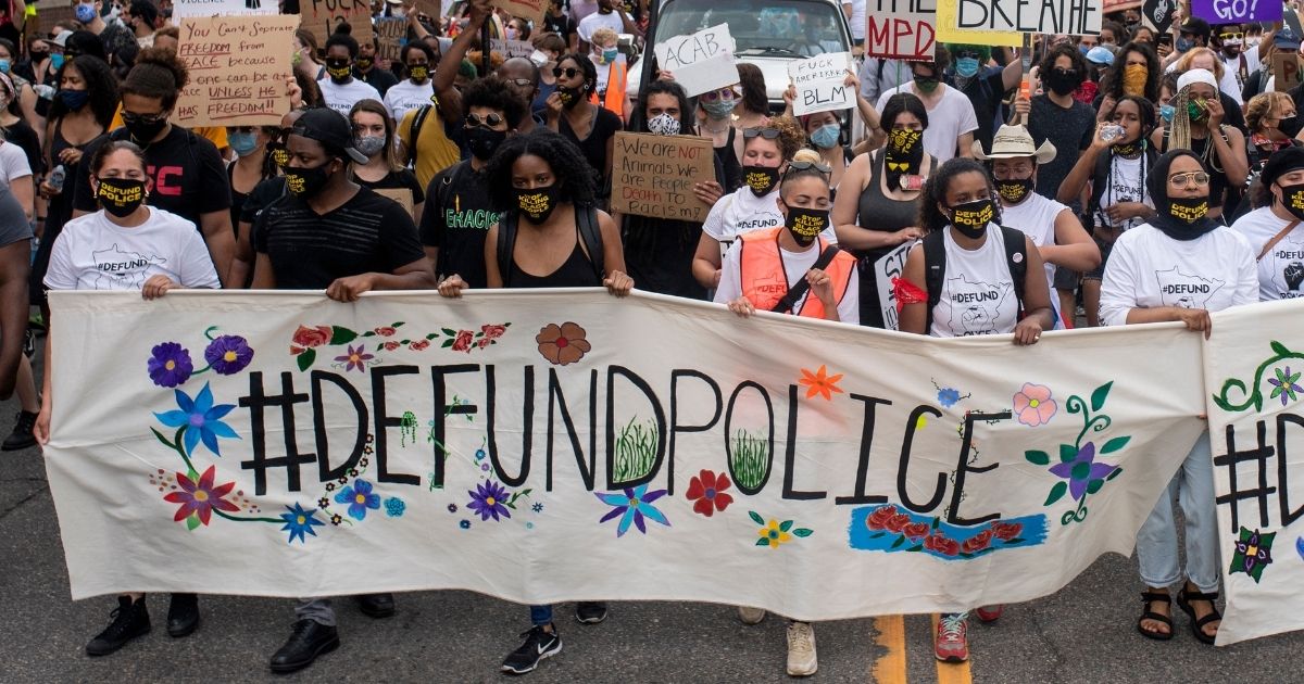 Demonstrators calling to defund the Minneapolis Police Department march on the city's University Avenue on June 6, 2020.