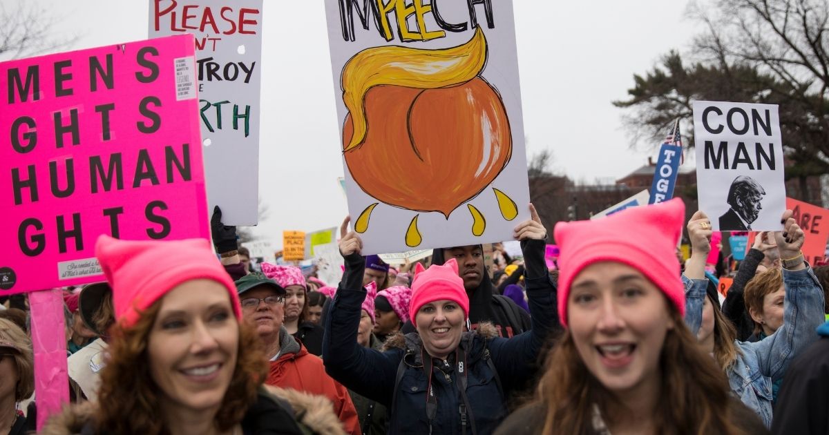 Marchers attending the Women's March on Washington carry signs critical of President Donald Trump on Jan. 21, 2017, in Washington, D.C.