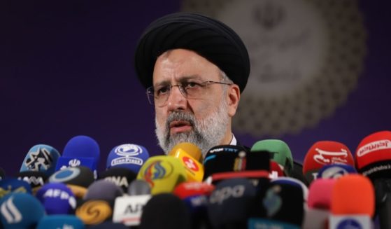 Iranian Chief Justice Ebrahim Raisi greets journalists as he arrives to submit his candidacy for Iran's presidential elections at the Interior Ministry ahead of the presidential elections scheduled for June on May 15, 2021, in Tehran, Iran.
