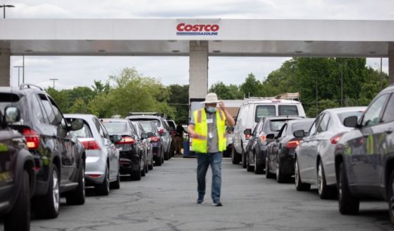Attendants direct cars as they line up to fill their gas tanks at a Costco on Tyvola Road in Charlotte, North Carolina, on May 11.