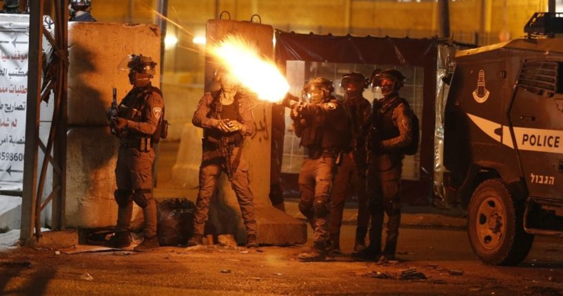 Israel Defense Forces soldiers fire tear gas at Palestinian demonstrators during an anti-Israel protest over tension in Jerusalem, at the Qalandiya checkpoint between Ramallah and Jerusalem in the occupied West Bank on May 11, 2021.