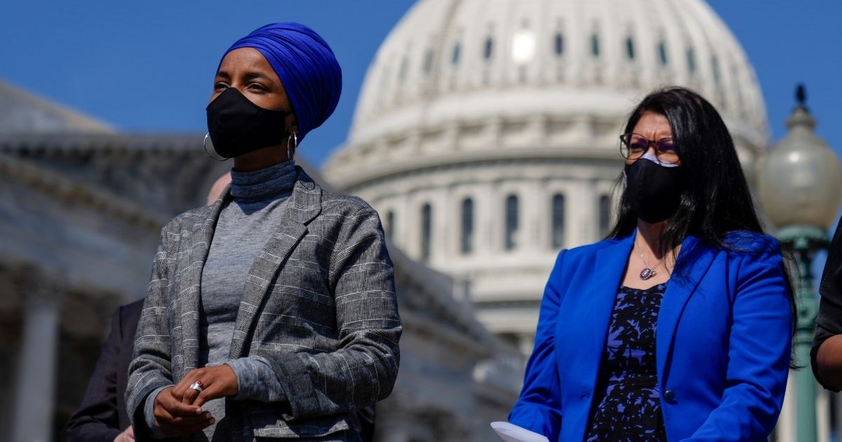 Democratic Reps. Ilhan Omar of Minnesota and Rashida Tlaib of Michigan attend a news conference to discuss proposed legislation outside the U.S. Capitol on March 11, 2021 in Washington, D.C.