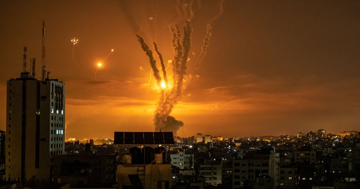 Rockets launched toward Israel from the northern Gaza Strip and response from the Israeli missile defense system known as the Iron Dome leave streaks through the sky on Friday in Gaza City, Gaza.