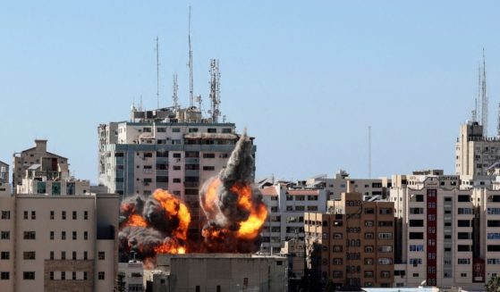 A ball of fire erupts from the Jala Tower as it is destroyed in an Israeli airstrike in Gaza City on Saturday.