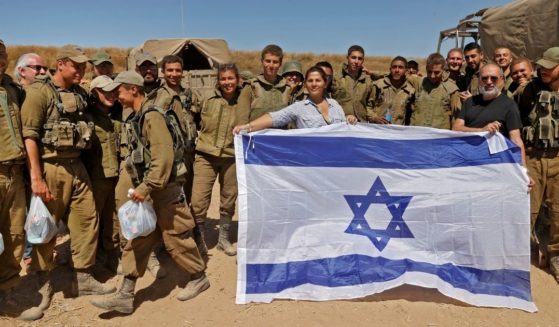 Israelis pose with soldiers along the border in the southern Israeli city of Sderot on Wednesday.