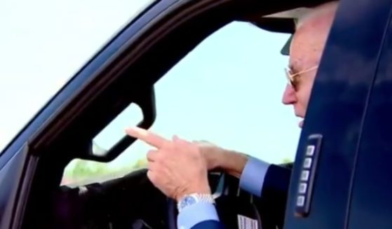 President Joe Biden jokingly threatened to run over a reporter who attempted to ask him about the tense situation in Israel on Tuesday as he test-drove a Ford truck in Michigan.