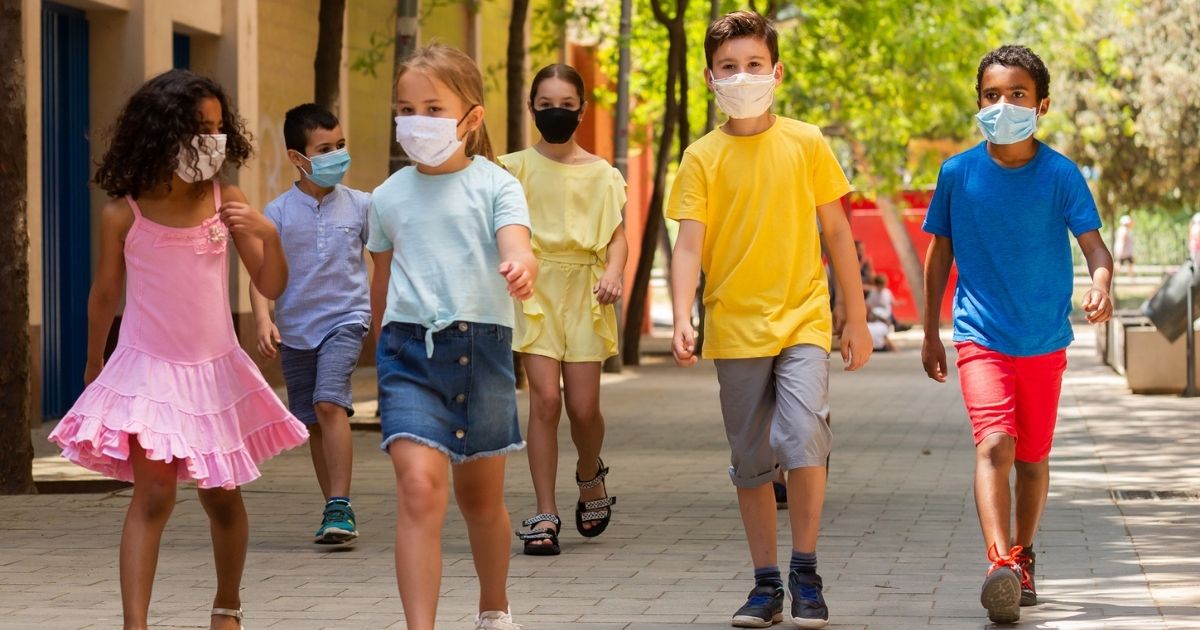 Kids wearing masks are pictured in the stock image above.