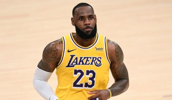 LeBron James #23 of the Los Angeles Lakers reacts after his three-pointer in double overtime to lead the Lakers to a 135-129 win over the Detroit Pistons at Staples Center on Feb. 6, 2021, in Los Angeles, California.
