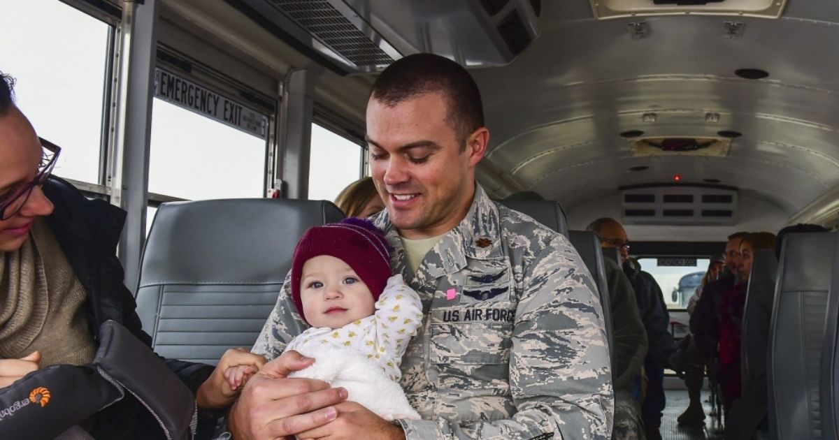 Eliza rides with her dad Maj. Matthew Lohmeier, 460th Space Wing executive officer, on her way to visit the Mission Control Station during Team Buckley Spouse and Family Day Center on Dec. 22, 2016. The event consisted of families given access to see the 460th Space Wing mission up close, with demonstrations from the operators, Defenders, and firefighters.